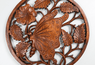a wooden butterfly wall hanging on a wall