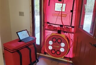 Retrotec blower door testing equipment testing to see how leaky a building envelope is.