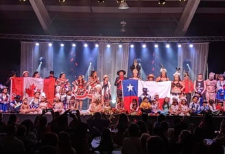 a group of people standing on a stage with a Chilean flag