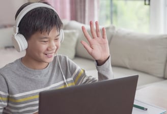 a boy with headphones and headphones on a couch