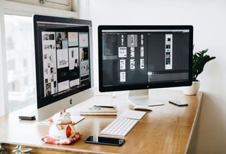 a computer monitor monitor and a keyboard on a desk
