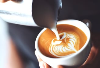 Barista preparing a fresh latte at a wedding or corporate event with Ancestral on Wheels mobilecoffe