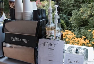 Espresso machine and flavored syrups set up for a corporate coffee cart event