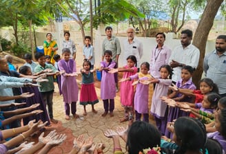 a group of people standing around a circle of hands
