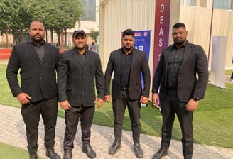 a group of men in suits standing in front of a building