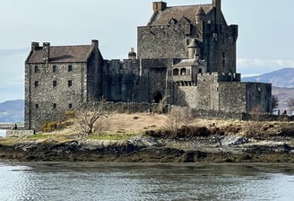 Castle in the day with water and countryside around