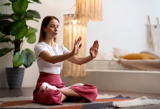 a woman sitting on a rug in a room
