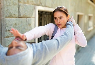 Woman diverts assailants attack and counters with a palm strike to the chin..