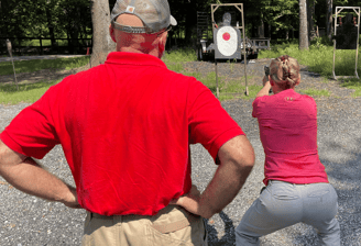 DT trainer on the shooting range with female student.