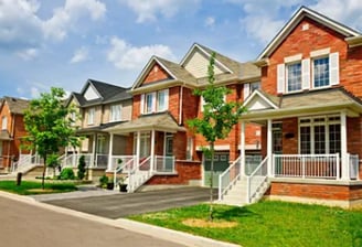 a row of houses with a driveway