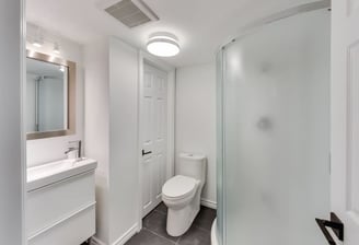 a guest bathroom with a toilet and a shower