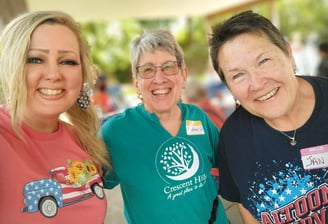 Smiling neighbors at the Memorial Day Picnic in Crescent Hills Park