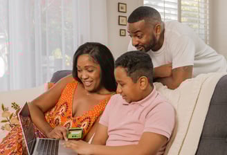 a family sitting on a couch in a living room