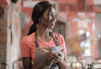 a woman in a apron and aprons holding a carrot