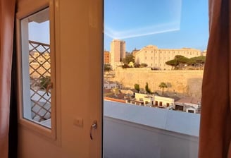 a view of a window with a view of a castle of Cagliari