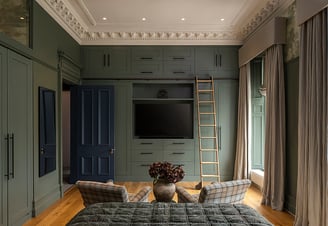 a bedroom with a ladder to climb up to the bed