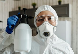 a person in a white lab coat and a white mask