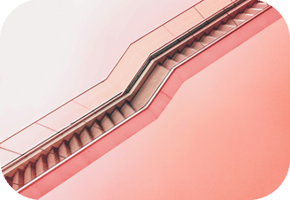 a staircase leading up to a building with a red sky background