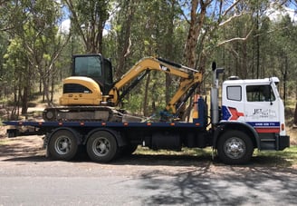 transporting an excavator to its new work location