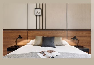 Sophisticated bedroom with natural walnut finishes, custom art pieces, and balanced design by SAVIA
