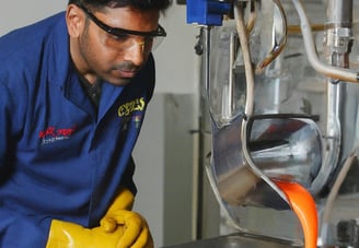 a man in a blue shirt and yellow gloves
