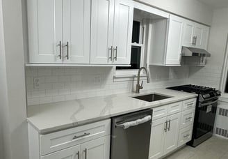 a kitchen with white cabinets and white cabinets