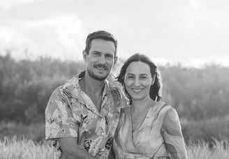 family business owners standing in front of dunes and bush