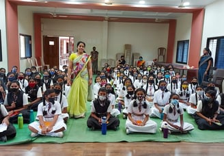 a group of children and adults in school uniforms