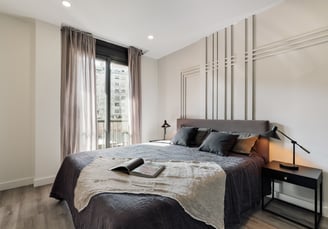 Elegant bedroom with wall panels, calm color palette and modern minimalist design in Barcelona