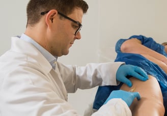 a doctor examining a patient's leg in a hospital