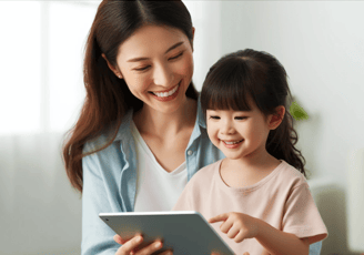 a woman therapist with a young child holding a tablet computer and smiling