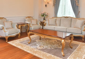 a living room with a calssic modern handmade sofa set, armchair, side table and coffee table