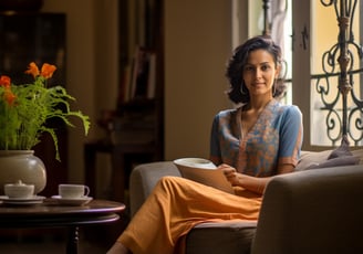 a woman sitting on a couch in a living room