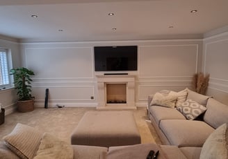 TV mounted on a wall above a fireplace with concealed cables