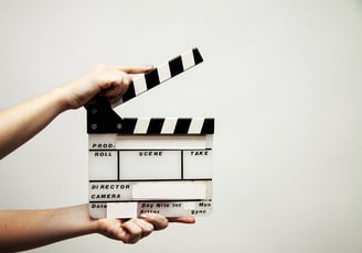 someone holding a movie style clapper board