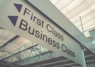 a sign that says first class business class in airport