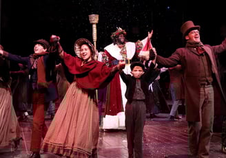 a group of people standing on a stage dancing