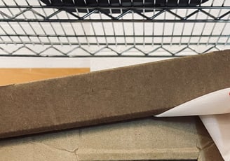 Closeup of the top of a cardboard filebox with a bit of Canadian flag sticking out