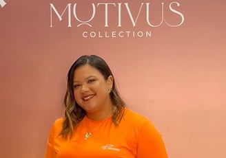 a woman in a bright orange shirt and jeans