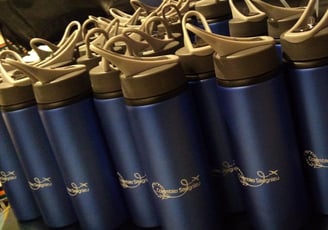 a bunch of blue water bottles with a black and white background
