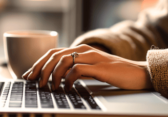 a person's hand on a laptop computer
