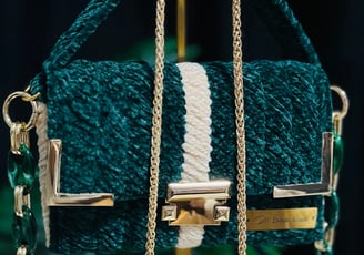 a green purse with a chain link chain