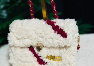 a white purse with a red and white purse