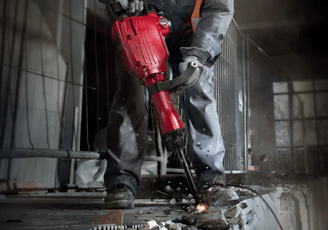 a man in a safety vest and a red helmet