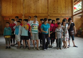 Tracey Billington with thetraditional long haired women at Huangluo Yao Village, China