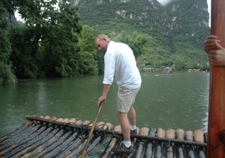 Nick Billington driving the raft at the Yulonghe scenic area, near Yangsh