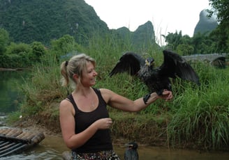 Tracey Billington with the cormorant fisherman at the Yulonghe scenic area, near Yangshuo, China