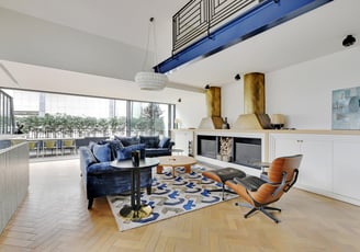 Fireplace lounge at Villa Bastille with cozy sofas and warm light