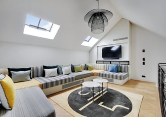 Mezzanine lounge at Villa Bastille with arcade games and TV