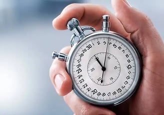 a person holding a stopwatch watch in their hand